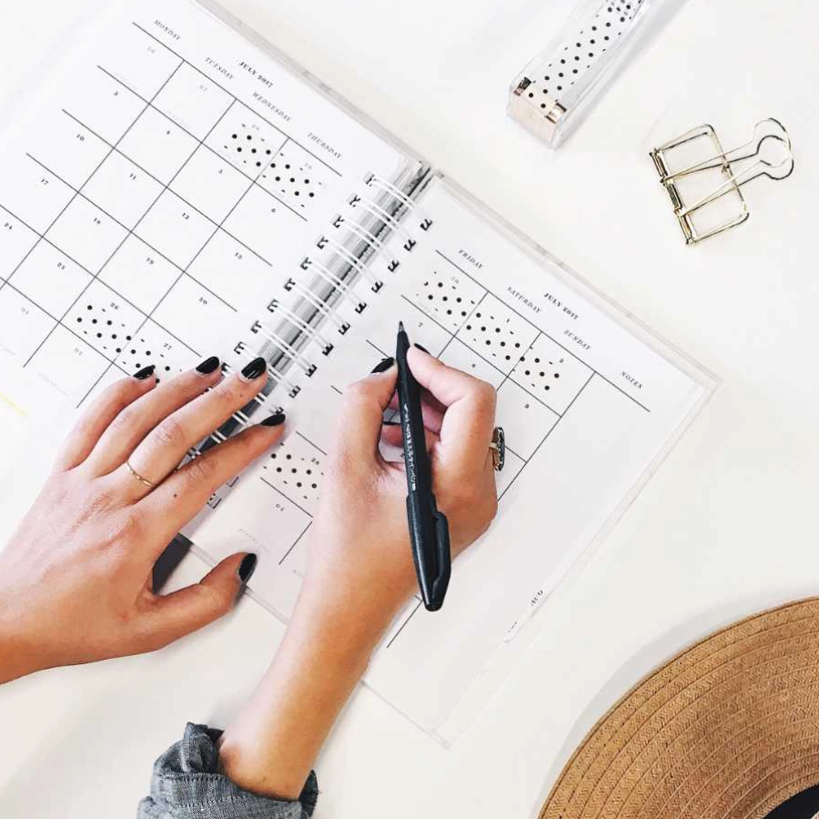 Woman writing in a wedding planner.